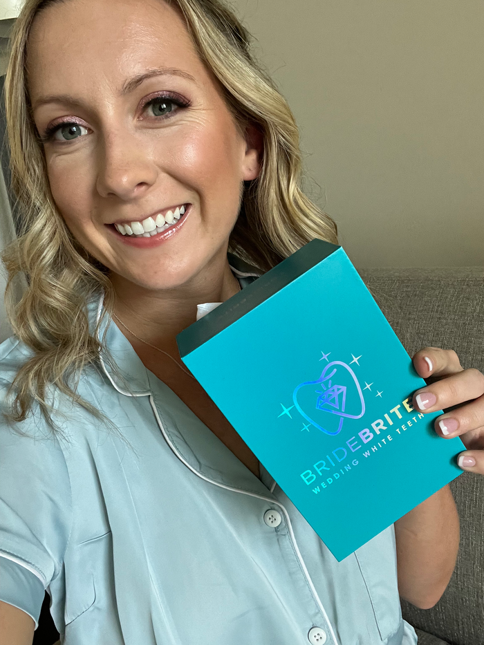 BRITEN customer Mallory M. smiling and holding her Bride Brite whitening kit
